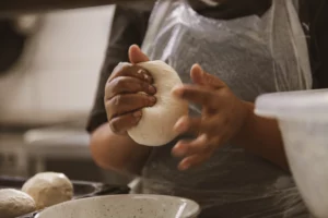 Hands kneading fresh dough for roosterkoek