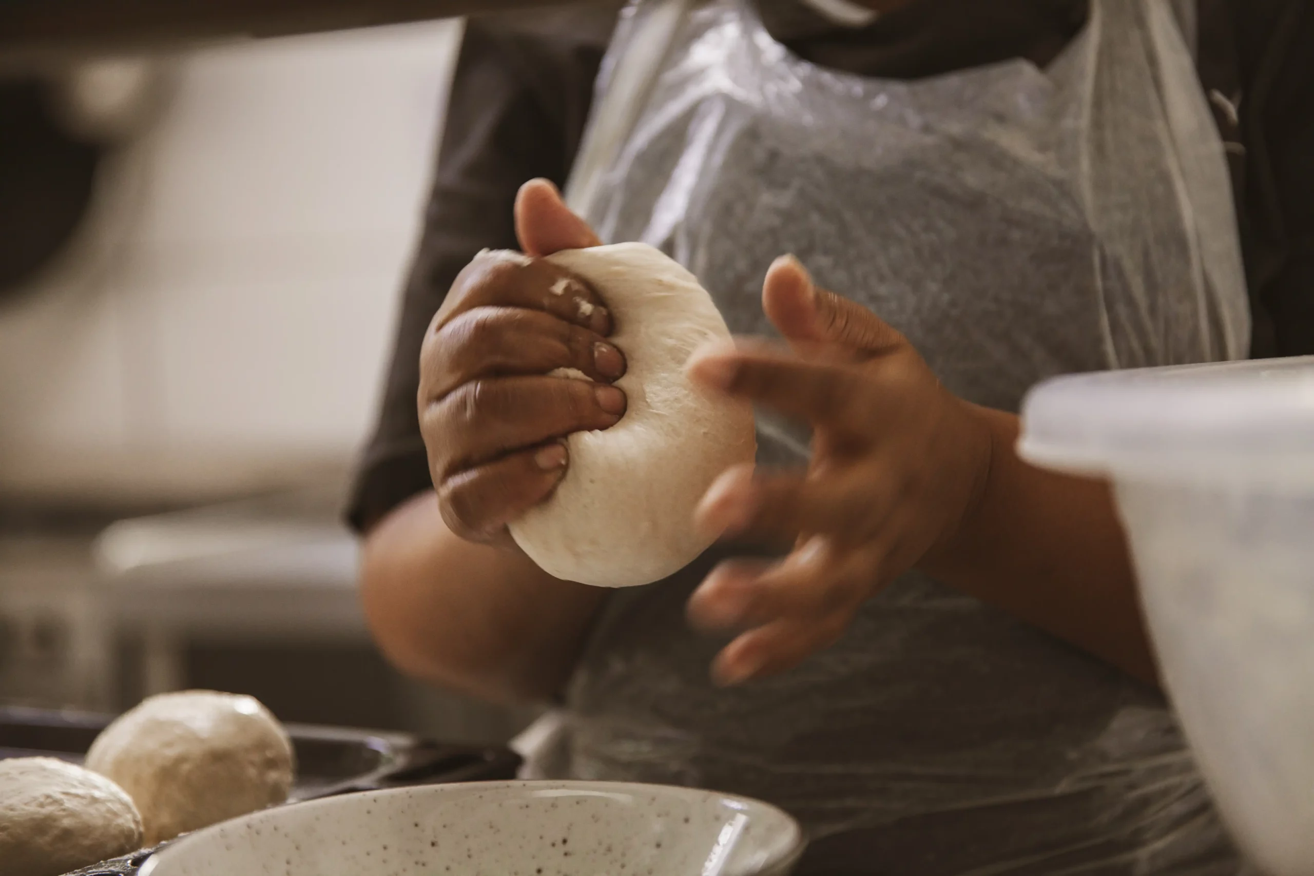 Hands kneading fresh dough for roosterkoek