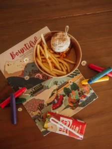 Kids meal with colouring book, fries and juice bo